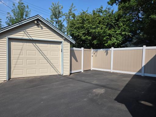 Large driveway that was recently seal-coated and garage.