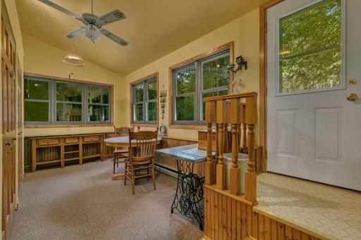 Spacious 4 season porch connects the garage and lower level