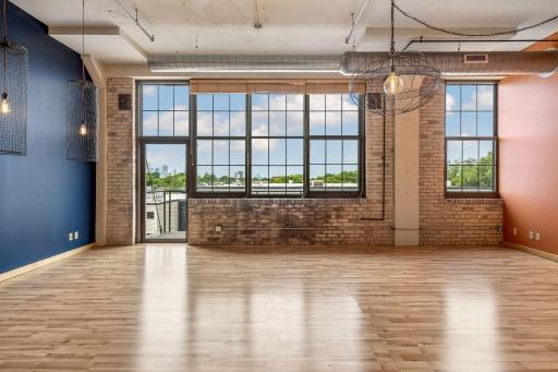 12 ft wall of windows in dining area. Access the balcony. Enjoy city views and stunning sunsets.