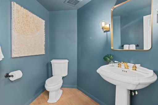 Main floor half bathroom is oversized and perfect for guests.