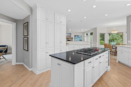 Prepare meals surrounded by spectacular views as expansive windows fill the kitchen with natural light and showcase the beautifully manicured grounds beyond.