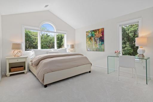 Family and guests will appreciate three spacious upper-level bedrooms, each thoughtfully updated with fresh paint, elegant cut-and-loop carpeting, and designer lighting. Expansive windows capture peaceful views of the beautifully manicured grounds.