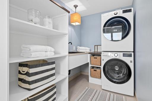 Conveniently located on the upper level, the thoughtfully designed laundry room features abundant storage, and generous workspace- making everyday tasks both efficient and effortless.