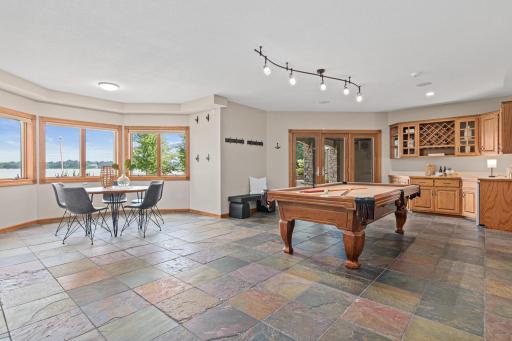 Whether hosting game nights, lake weekends, or casual gatherings, this incredible lower level delivers with a dedicated billiards area, walk-up bar, cozy family room, and private fifth bedroom- all with convenient access to the lakefront setting.