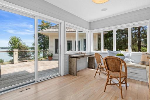 The sunny breakfast area offers a peaceful place to begin your day while overlooking the home's spectacular lake views.