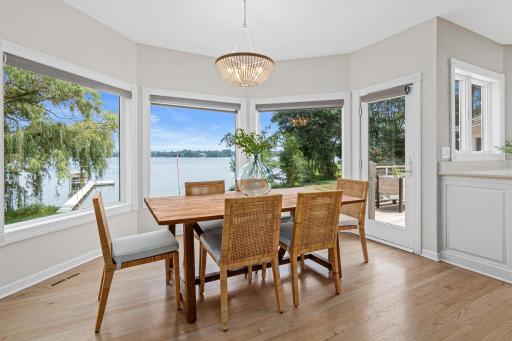 Surrounded by walls of windows, the informal dining area creates the feeling of dining outdoors while enjoying incredible views of the lake.