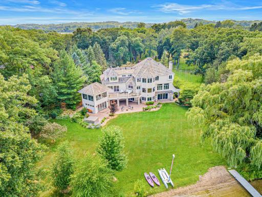 A truly extraordinary setting featuring nearly three acres of park-like grounds, a winding driveway, mature trees, ever-changing perennial gardens, and over 300 feet of pristine, level sandy shoreline on Turtle Lake.