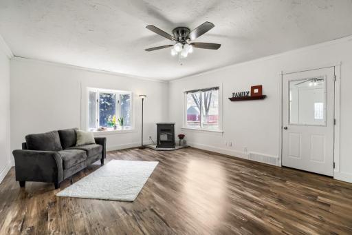 Large living room with bay window and pellet stove a