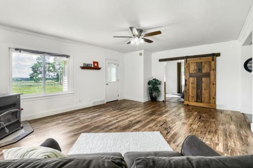 View from the living room toward the main floor bedroom with a sliding door