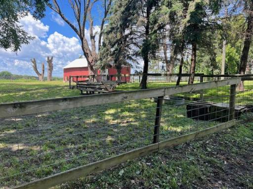 View of the fenced Pasture around the barn with watering troughs