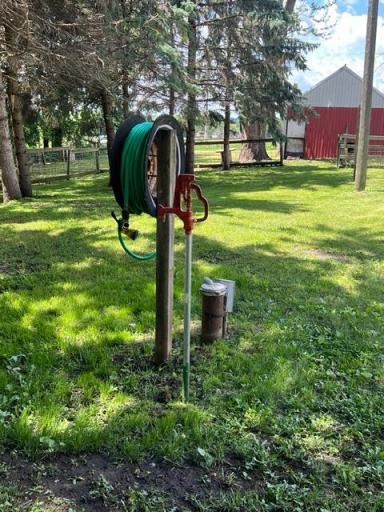 Water hydrant between the barn and shed