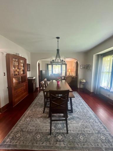 Formal dining room with hardwood floors build it china cabinet, and new light fixture.