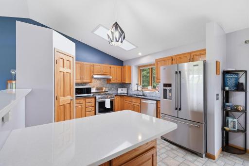 You'll love this new quartz peninsula and expanded pantry closet.