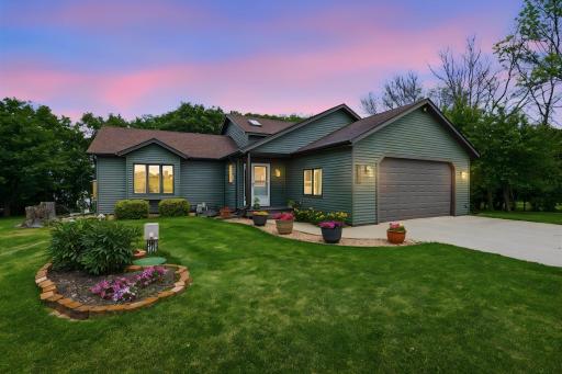 New siding, concrete driveway, and manicured landscaping give this home impressive curb appeal.