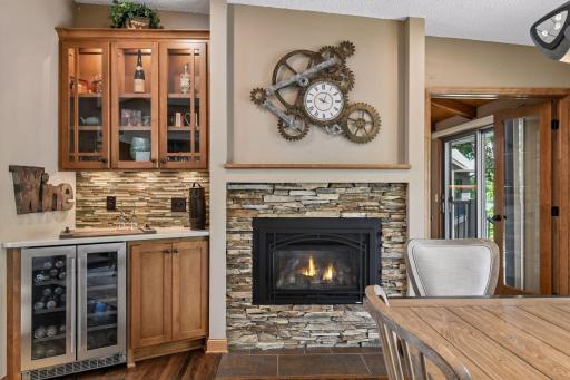 Formal dining has gas fireplace & beverage refrigerator with built-in cabinets.