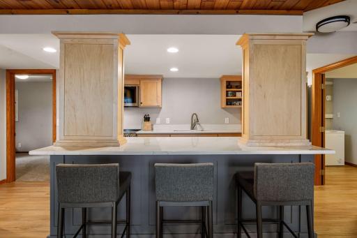 Lower level kitchen with counter seating.