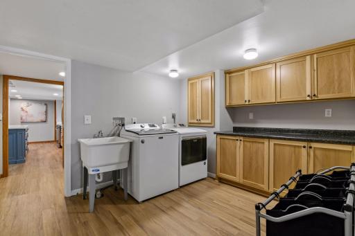 Lower level finished laundry with built-in cabinets.