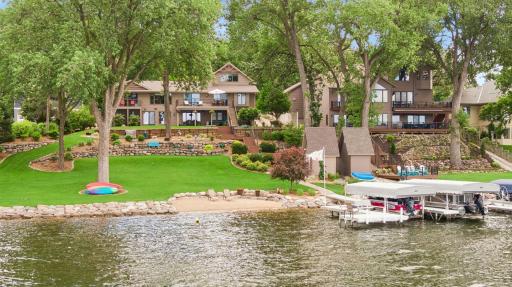 Backyard has gentle slope to beach, dock and lake.