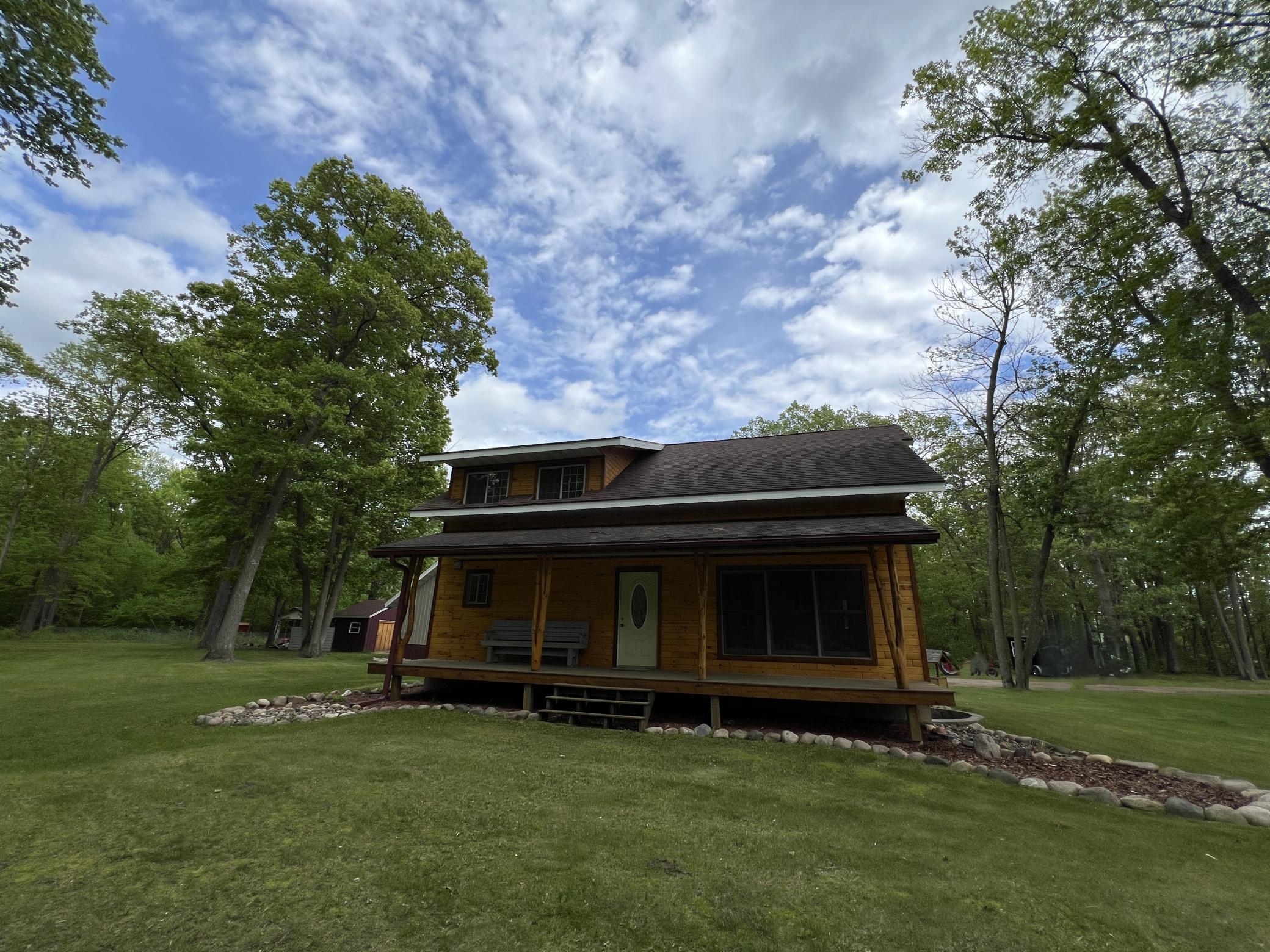 Rear covered porch and nicely landscaped. Picture has been digitally altered to removed personal belongings.
