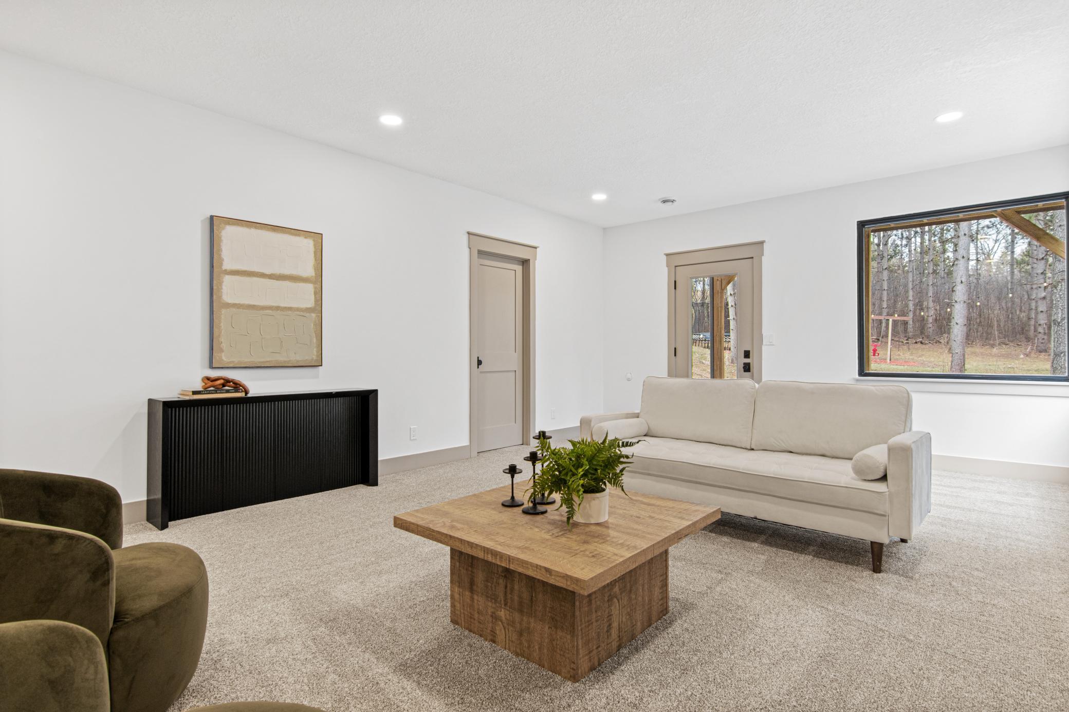 Spacious family room offers flexibility for movie nights, games, and gatherings.