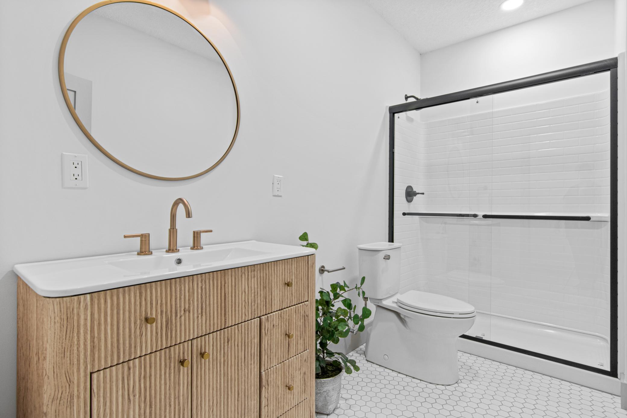 A spacious bath serves the lower level with style and convenience.