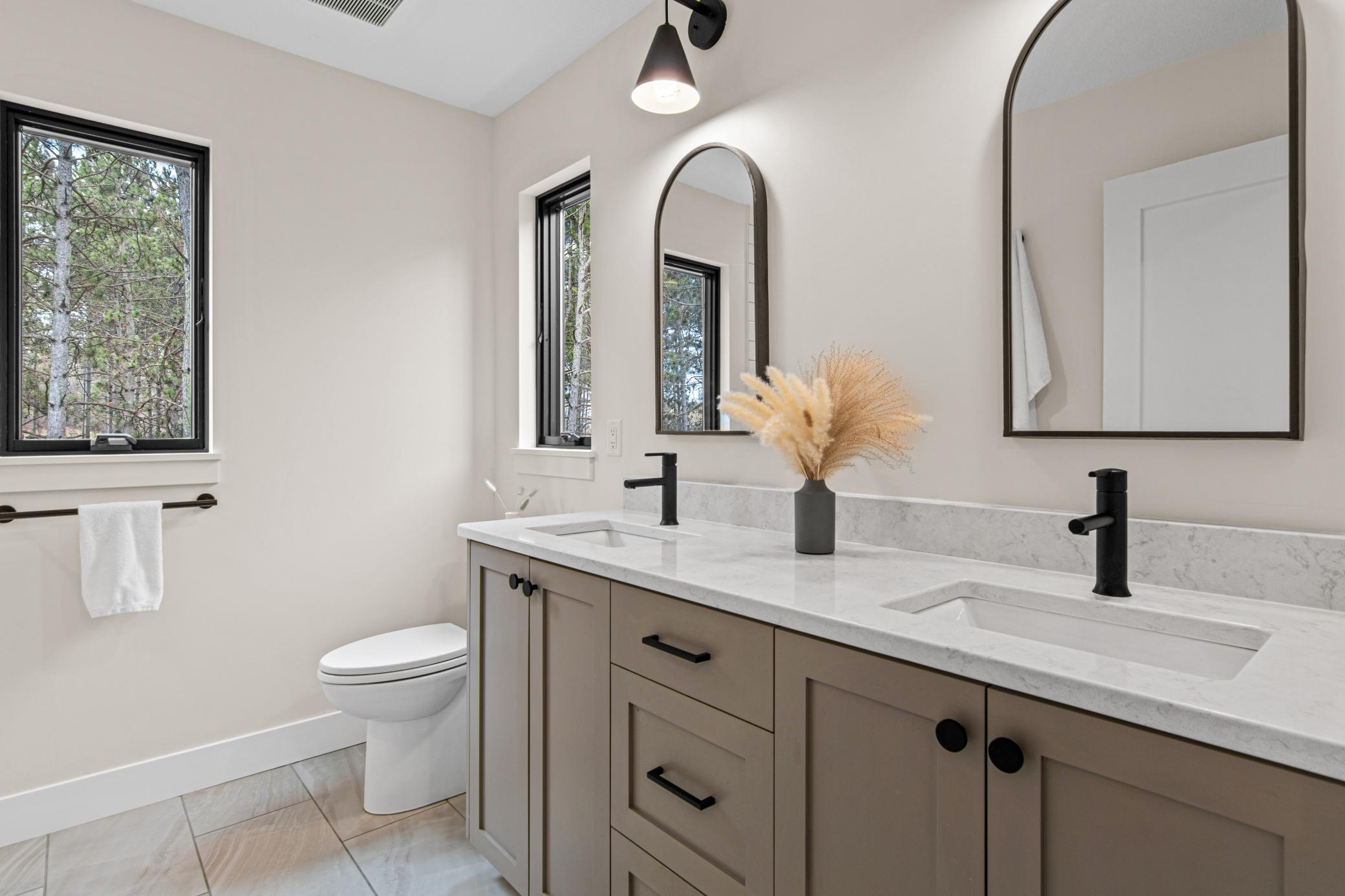 Quartz countertops and a double vanity provides room to start and end the day with ease.