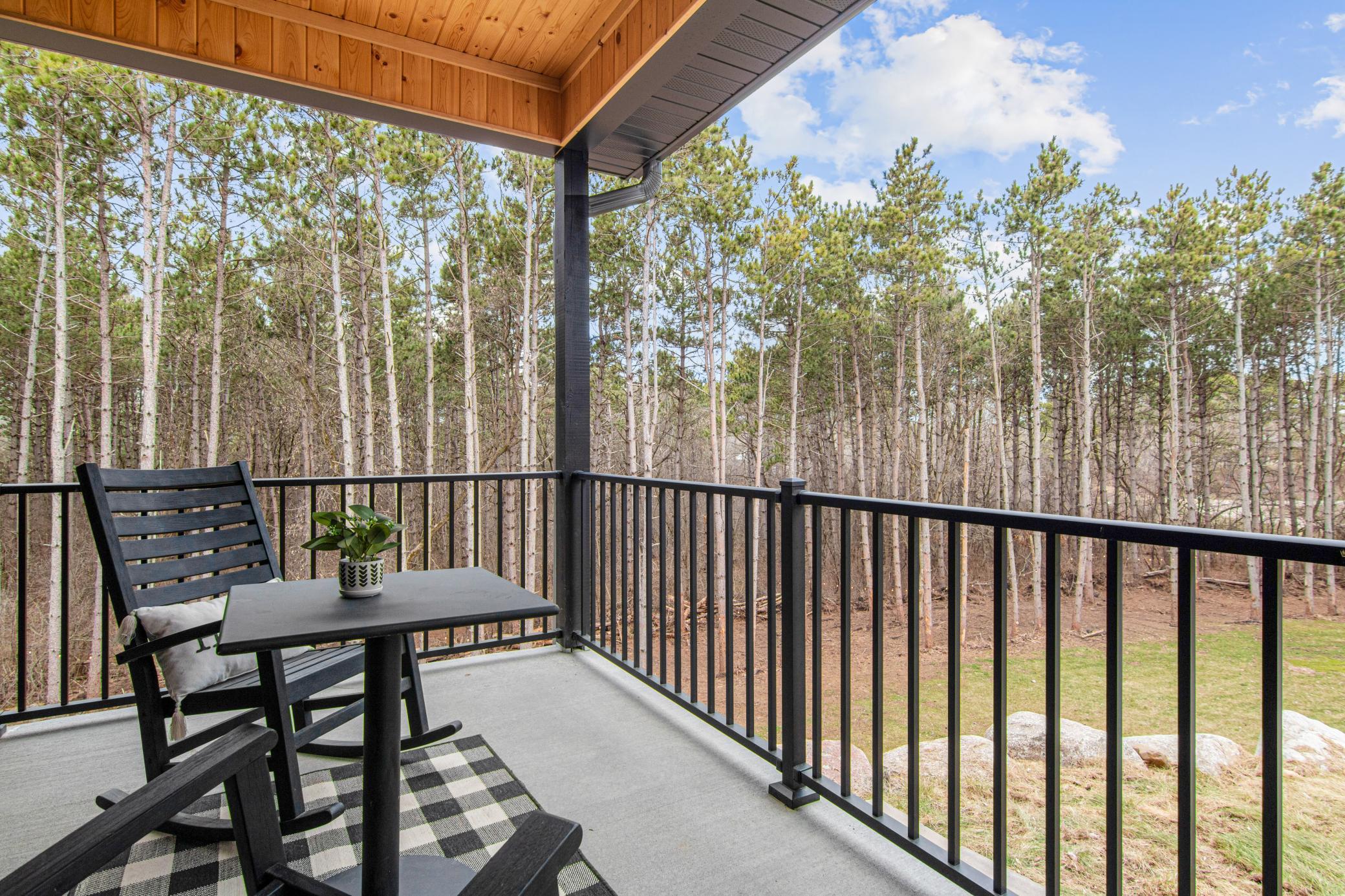 Covered front porch offers a quiet place to take in the wooded views and natural surroundings.