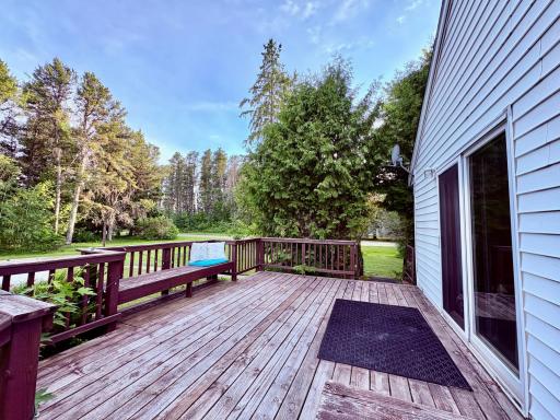 South side deck with bench area and patio door