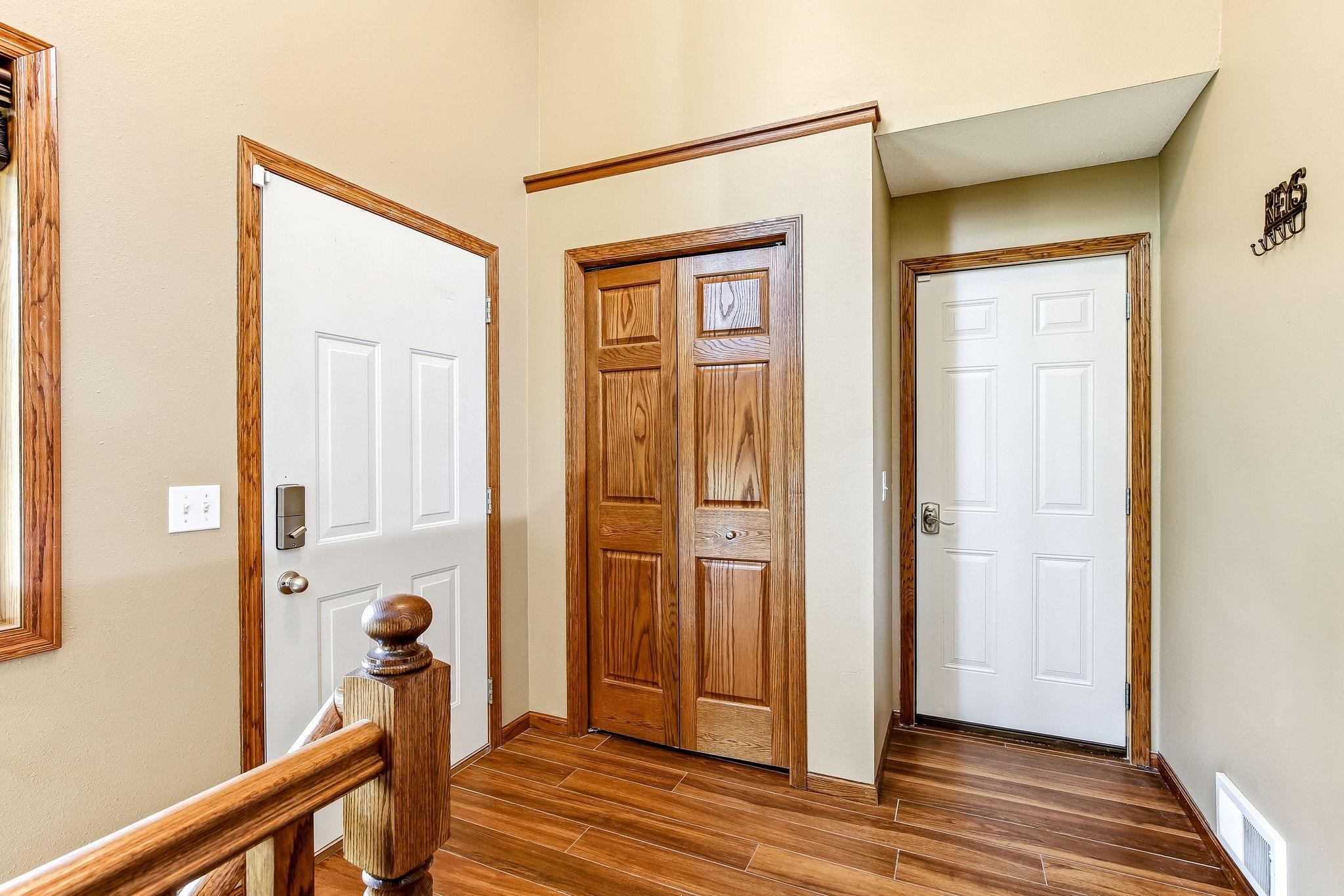 Welcoming entryway featuring durable tile flooring, a convenient coat closet, and direct access to the garage. The functional layout provides everyday convenience with ample space for coats, shoes, and seasonal gear.