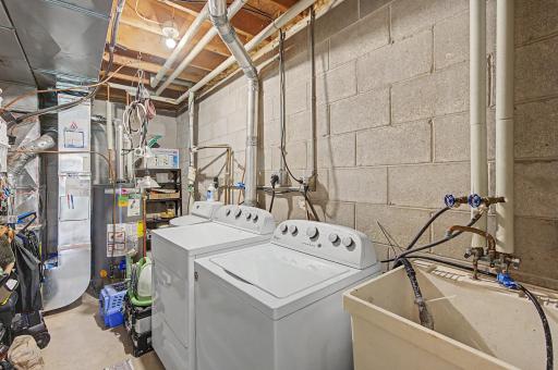 Clean and organized laundry room with shelves for storage.