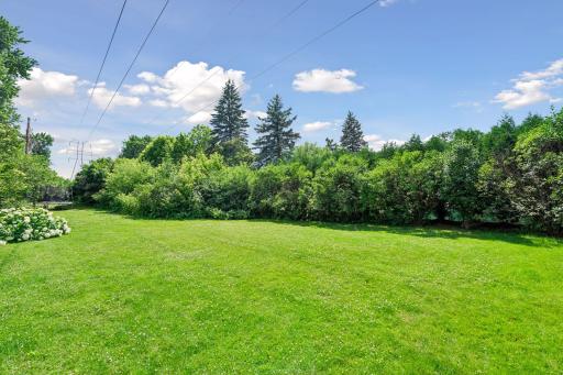 Beyond the rear property line, a rare utility easement provides a park-like extended yard without the added property tax burden.