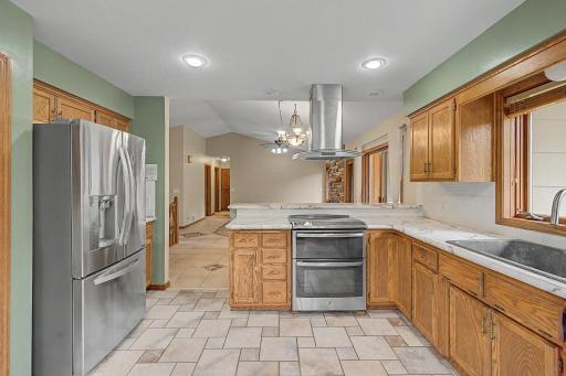 Large kitchen complete with stainless steel appliances.