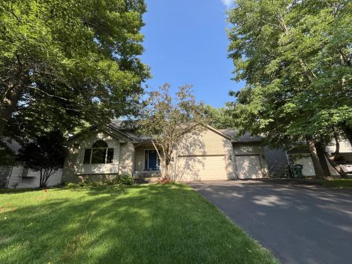 Solid brick front home with stately windows and fresh painted front door.