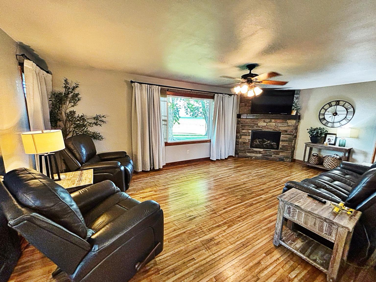 Refurbished hardwood floors and cozy gas fireplace