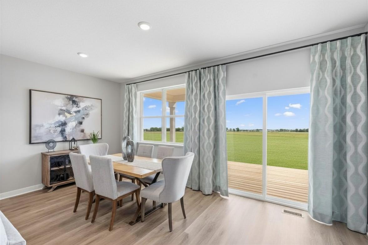Dining space that leads to your covered deck. Model photo, options and colors may vary.