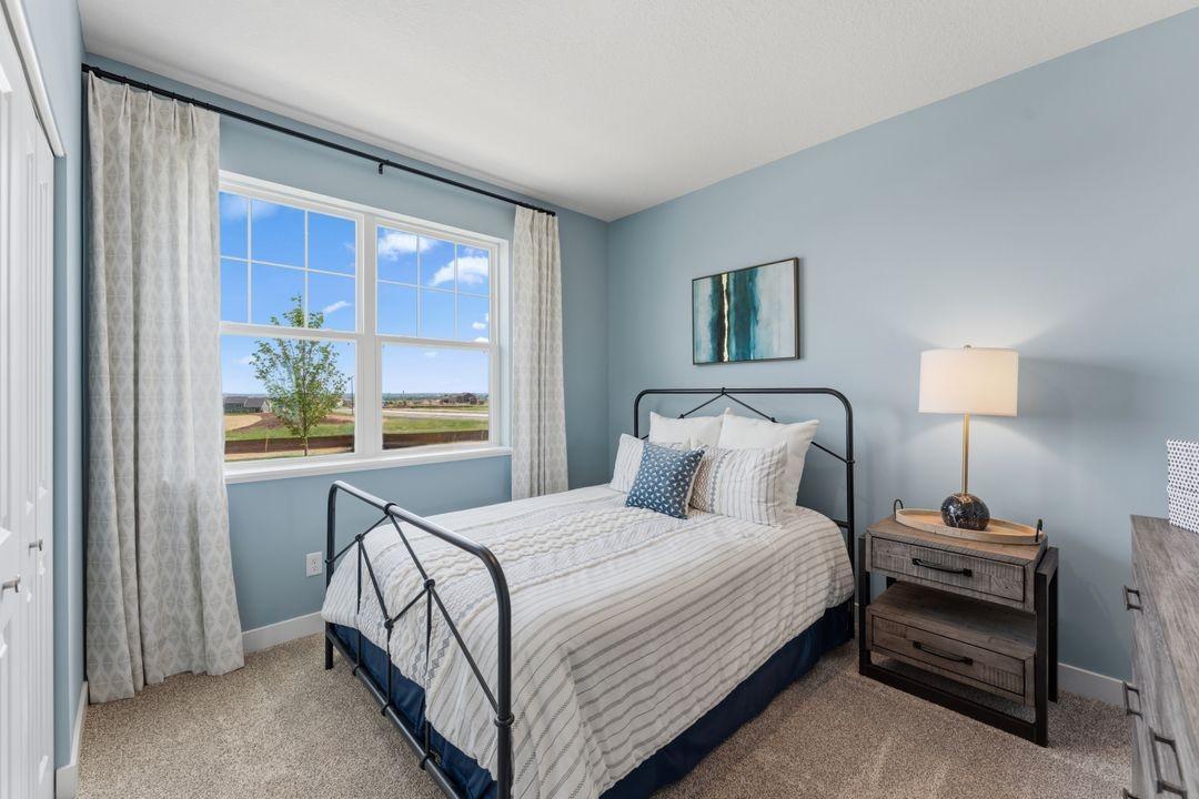 A bedroom at the front of the home could easily be an office, sitting room or hobby room! Model photo, options and colors may vary.