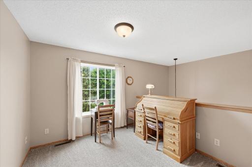 Versatile upper-level loft ideal for a home office, reading nook, or hobby space.