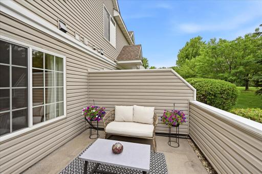 Private patio overlooking green space, perfect for relaxing outdoors.