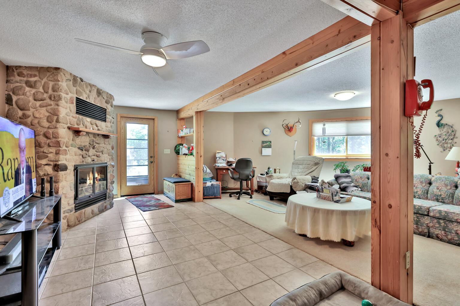The first level of the property is huge and contains the family room, fireplace, 4th bedroom and an aviary! The red phone can stay with the home, if the buyer wishes.
