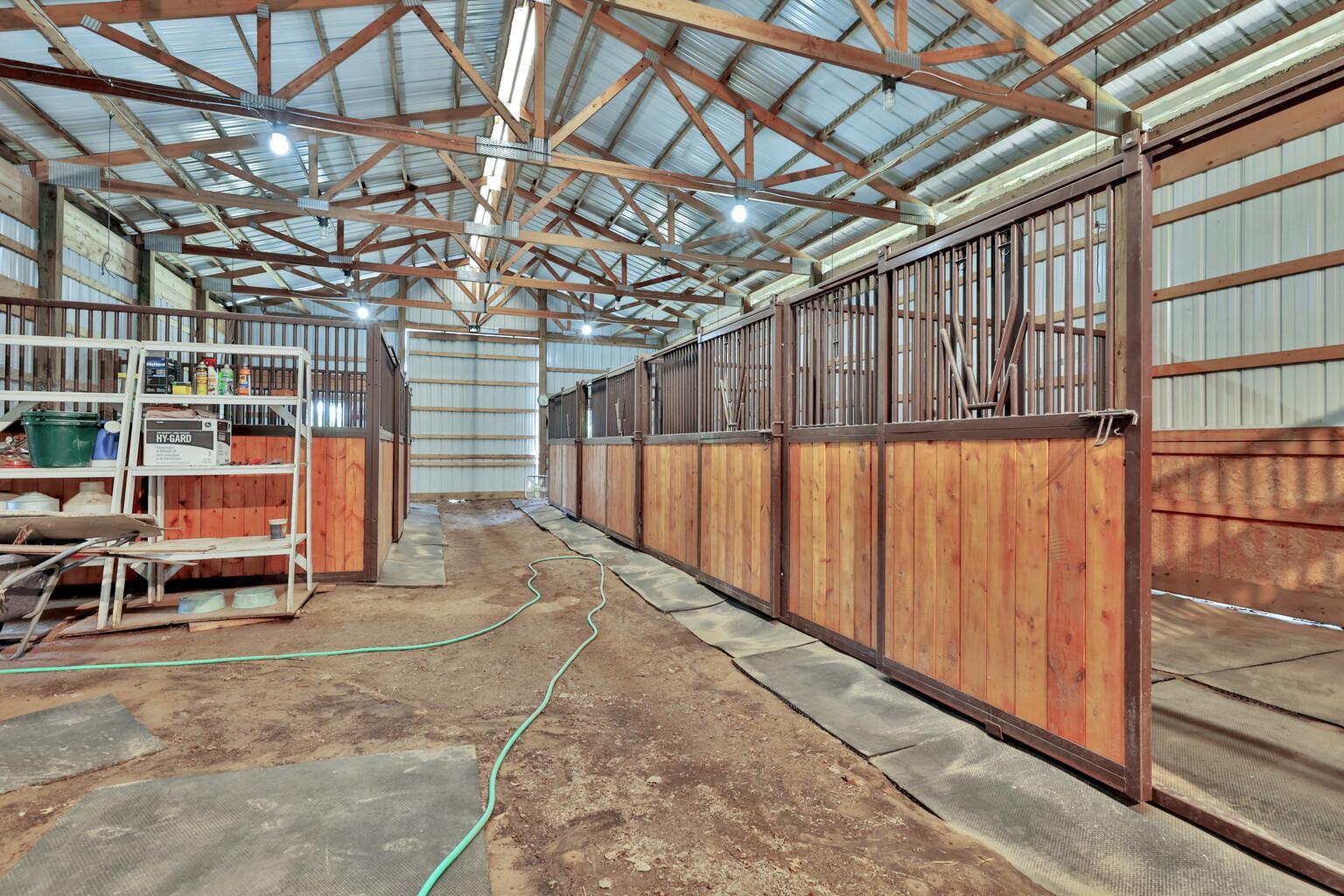 The barn includes a tack room and six stalls.