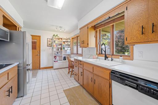 Classic, galley-style kitchen with ample storage & breakfast nook.