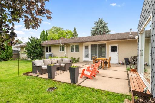 Retreat to your private outdoor oasis with cement paver patio, large green space and incredible shed!