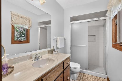 Owner's bath with newer shower tile and glass door.