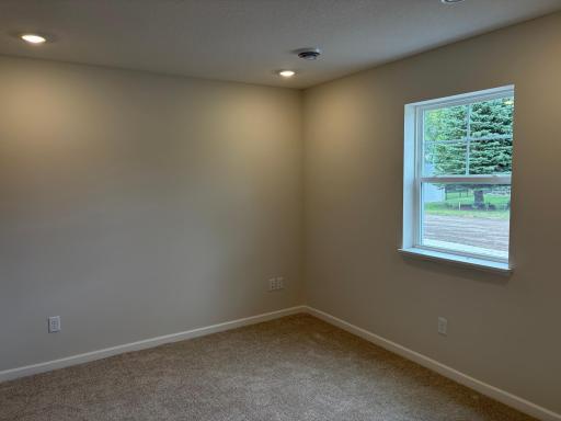 At the entry of the home, we have a spacious rec. space that is great, as a secondary living area, office, or even a makeshift 4th bedroom when you need added space!