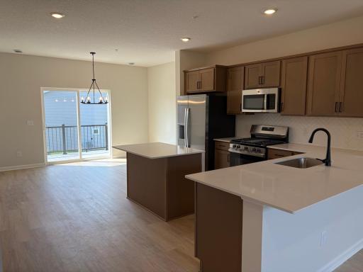 A reverse look at the kitchen offers great lighting and brings the kitchen and the dinette together.