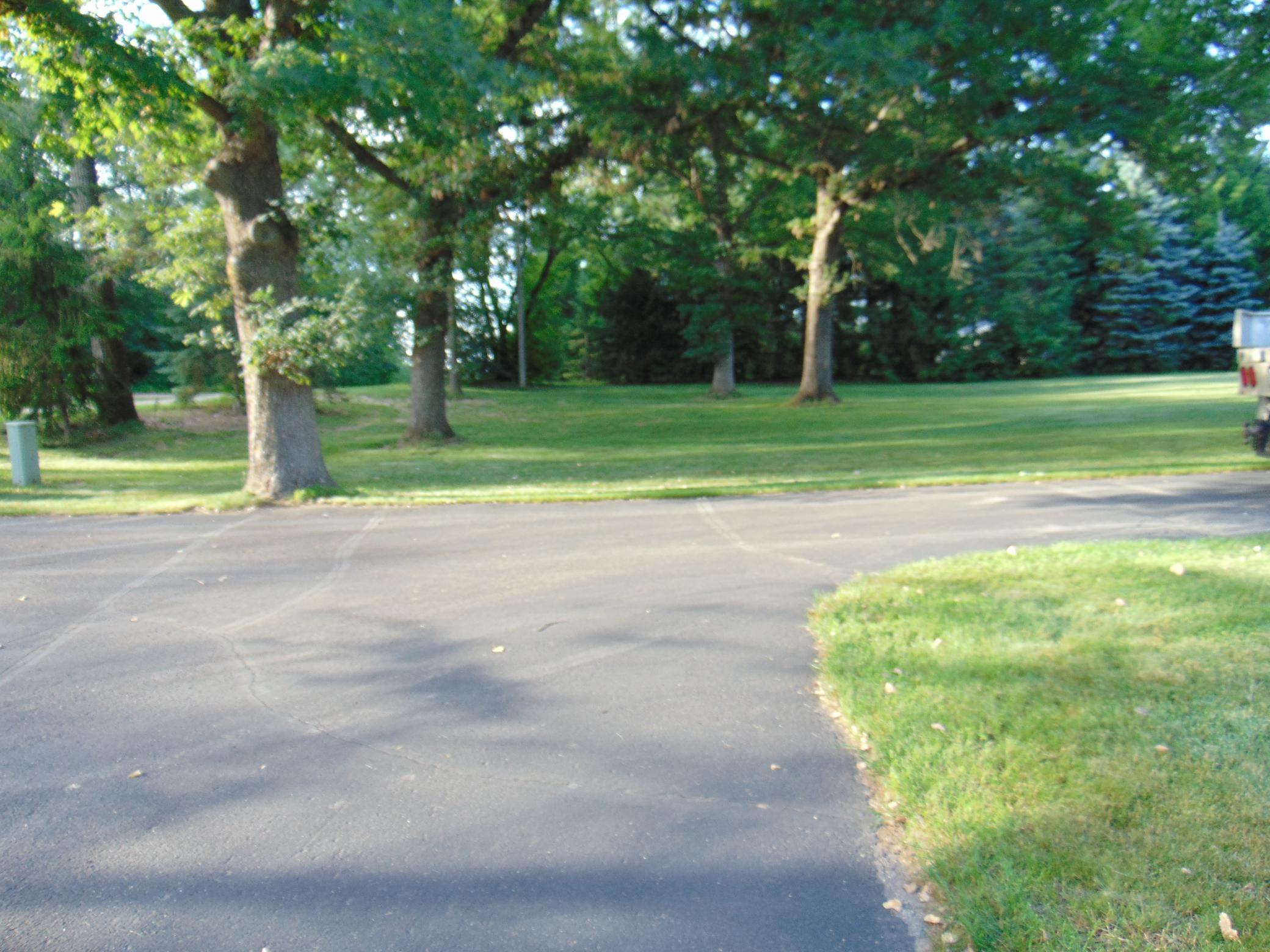 Asphalt drive to both garages