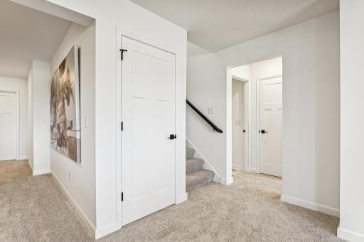 (Photo of a decorated model, actual homes finishes will vary) The stairs lead to the finished basement.