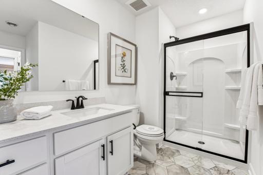 (Photo of a decorated model, actual homes finishes will vary) Lower-level bath.
