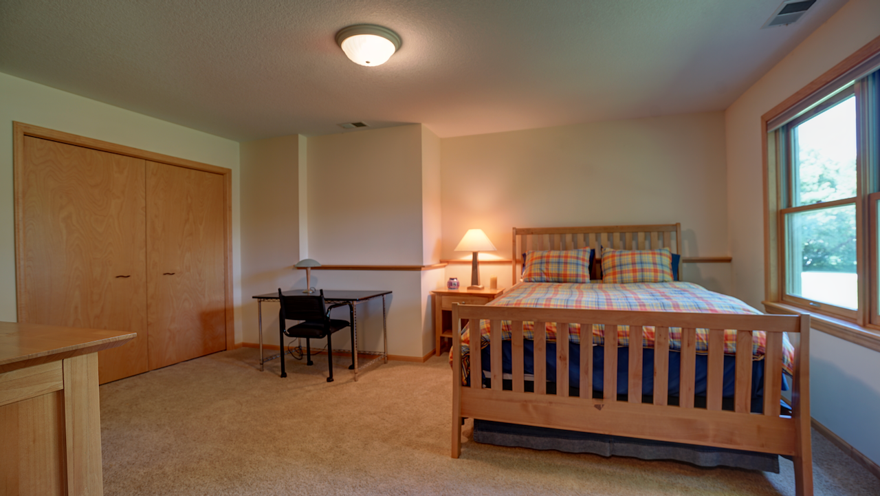 Bedroom 4 is an impressive 20x15 space finished with light maple trim accents and a massive full-wall closet build.
