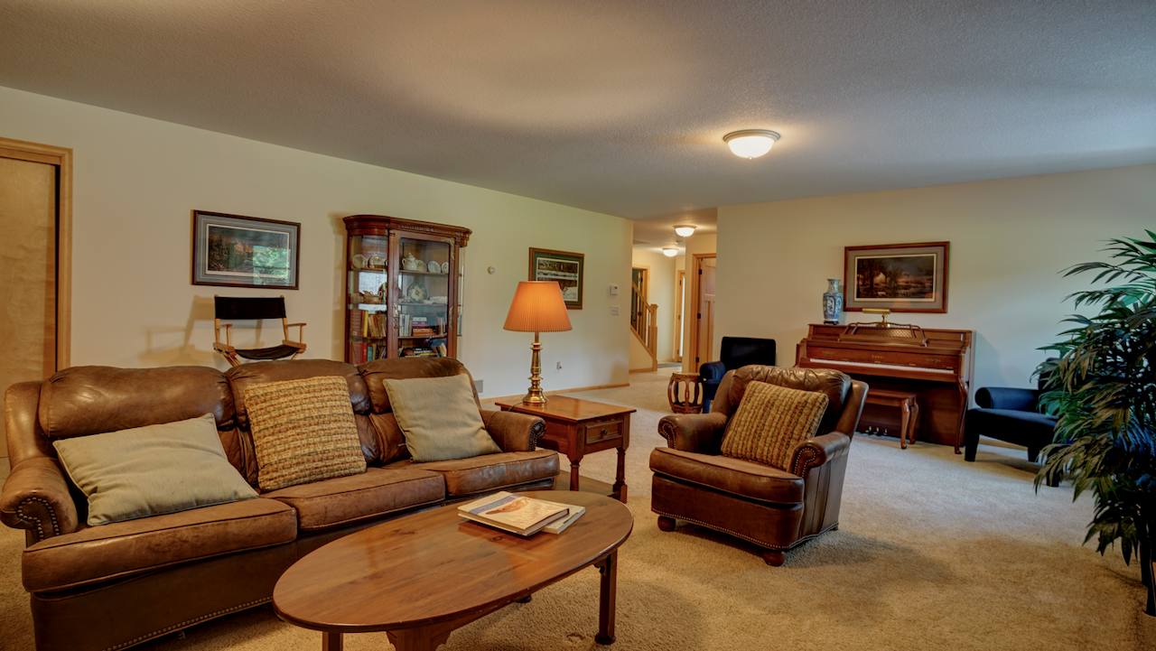 Step into the massive 20x28 lower-level family room, offering high ceiling clearances and incredible flexibility for entertaining.
